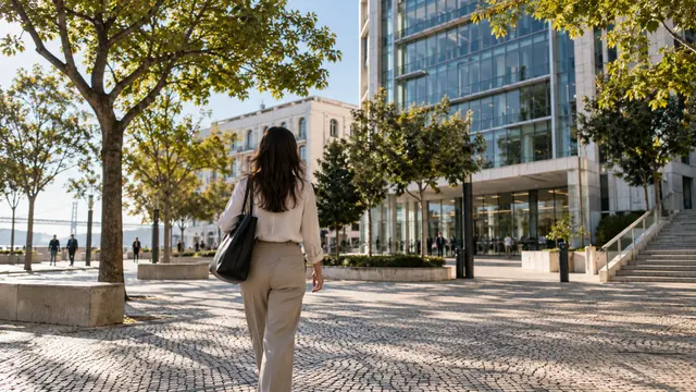 An adult on their first morning commuting to a contemporary Portuguese office building.