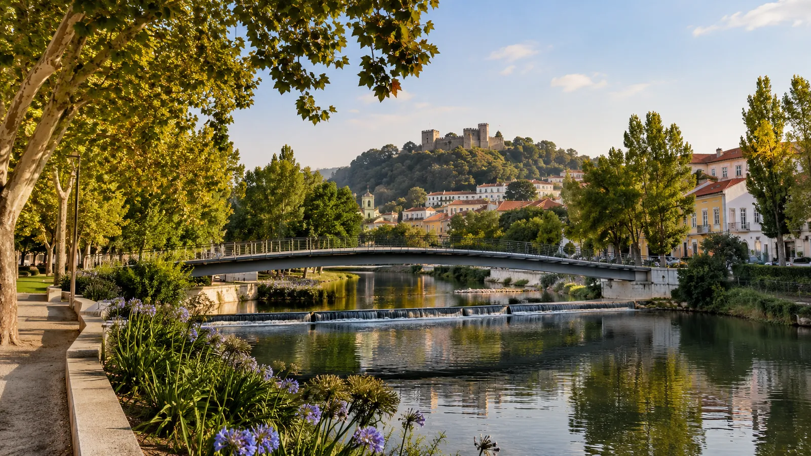 Leiria-inspired small-city river park with a pedestrian bridge.