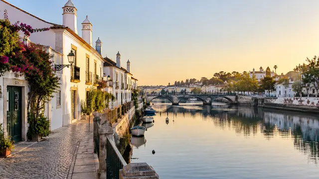 Tavira-inspired riverside lane with white houses.