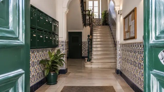 A well-maintained Portuguese apartment building shared entrance with mailboxes.
