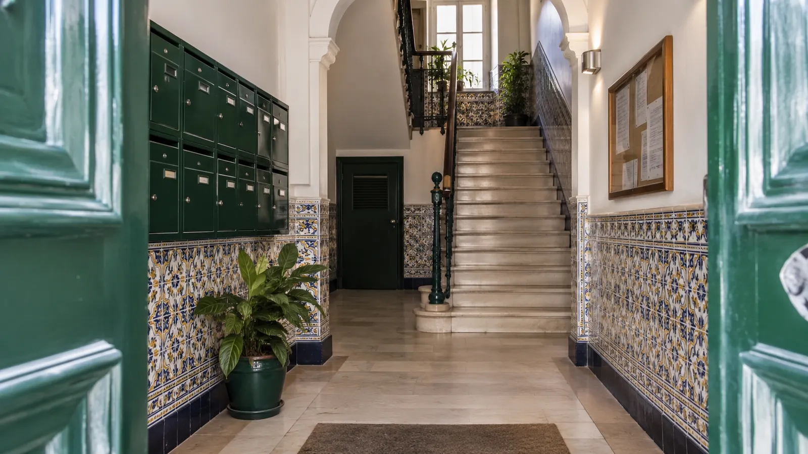A well-maintained Portuguese apartment building shared entrance with mailboxes.
