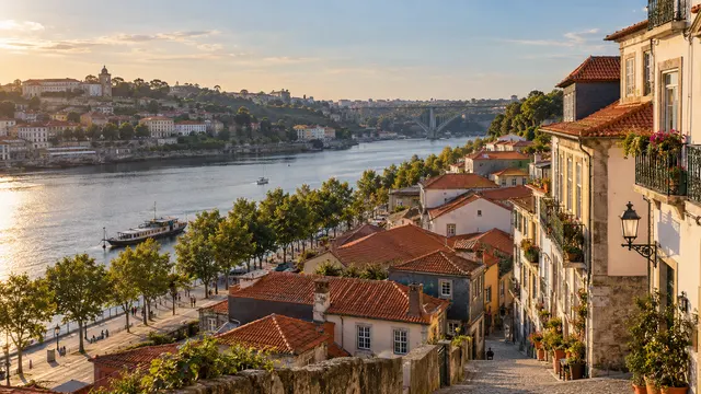 Colourful houses and rooftops beside a calm river